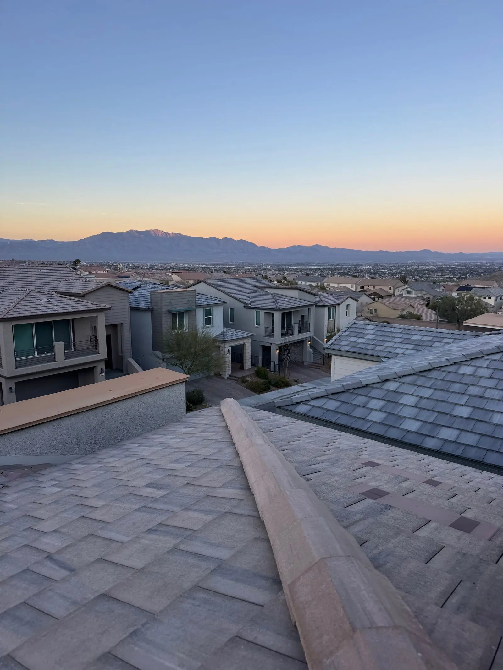 Las Vegas suburban neighborhood at twilight with mountains behind