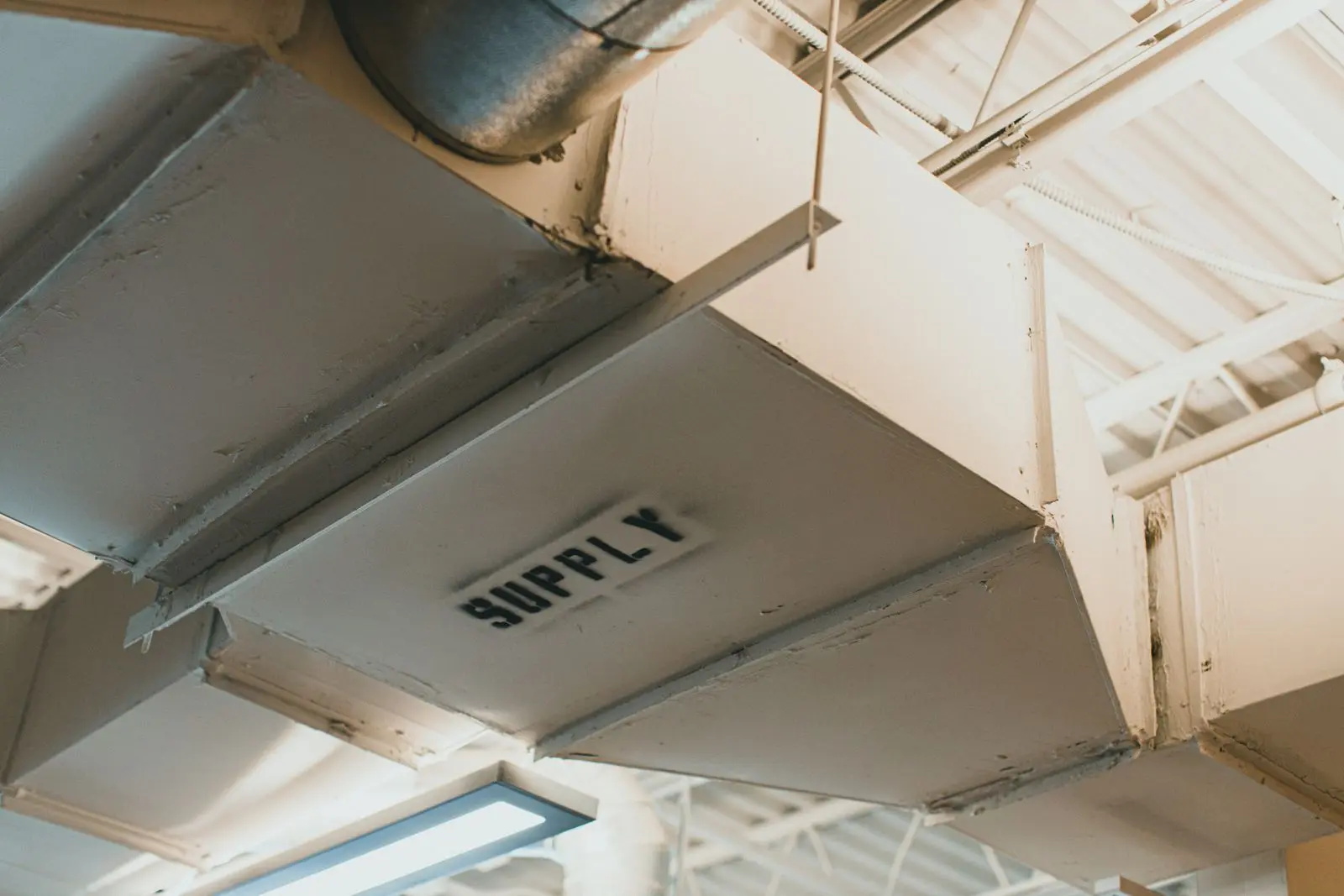 Metal supply air duct labeled supply