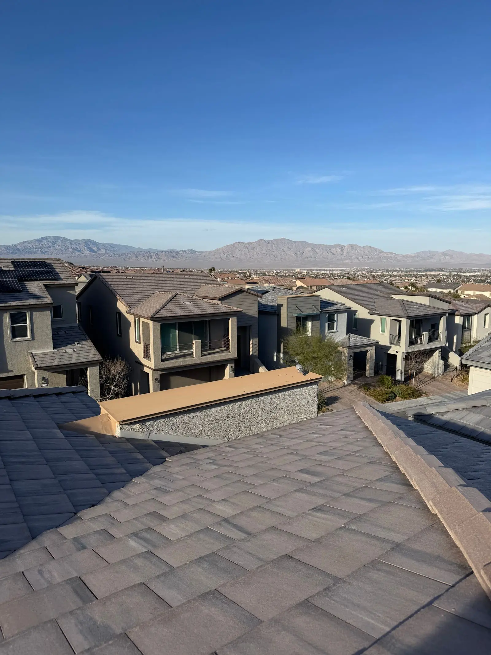 Tile rooftops of a Las Vegas neighborhood with desert mountains