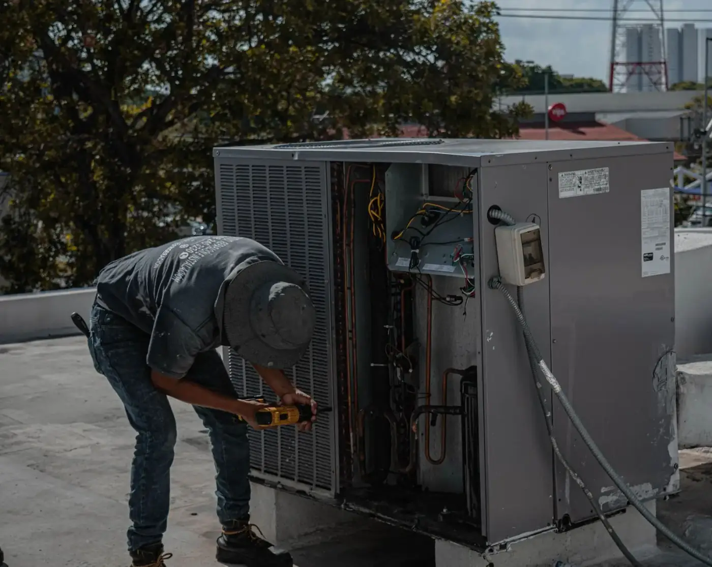 Technician servicing a rooftop package unit